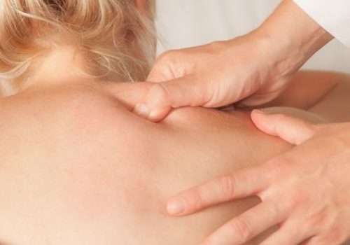 registered-massage-therapy registered massage therapist working on woman's back